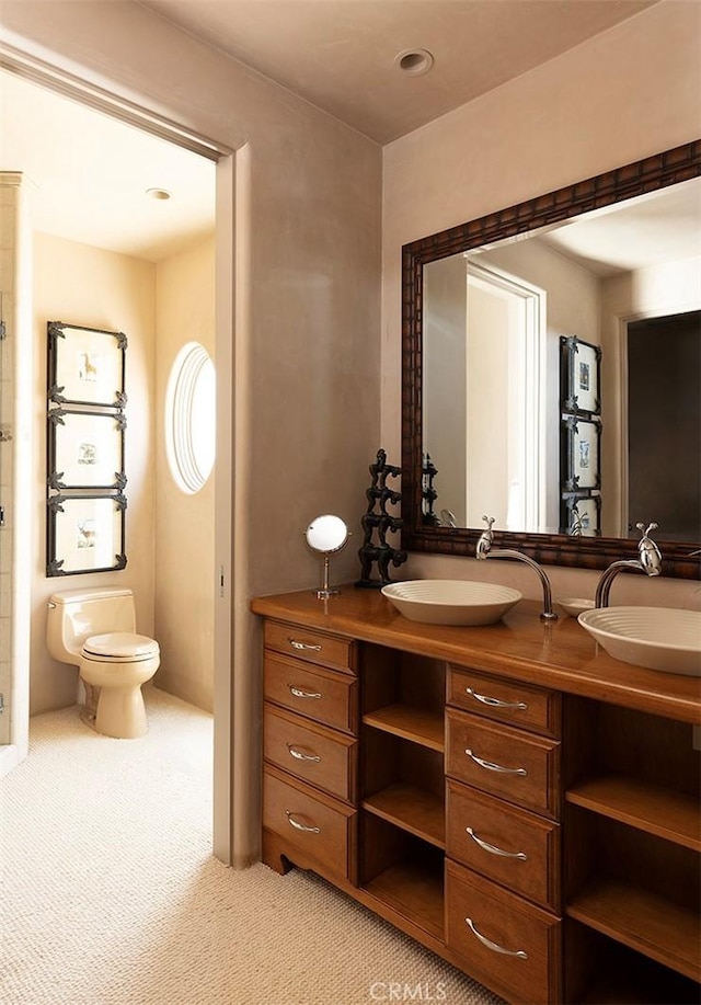 bathroom featuring toilet and vanity