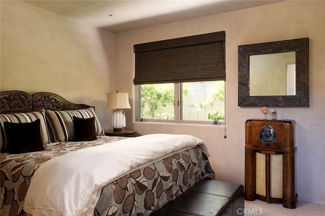 bedroom featuring light carpet