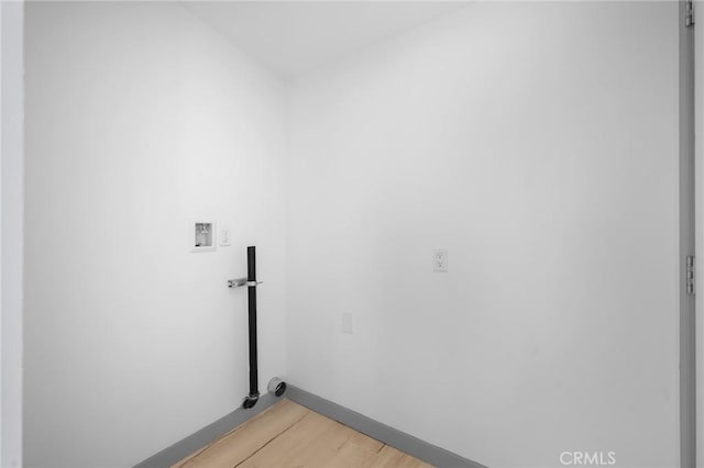 laundry room featuring washer hookup and hardwood / wood-style floors