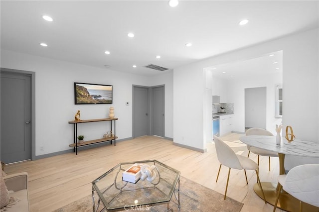 living room with light hardwood / wood-style flooring