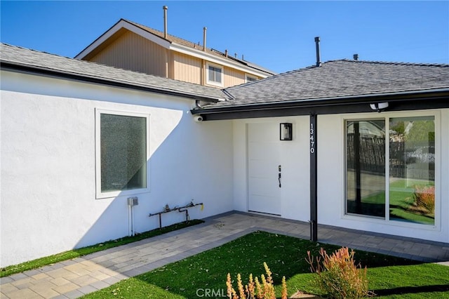 property entrance featuring a patio area and a yard