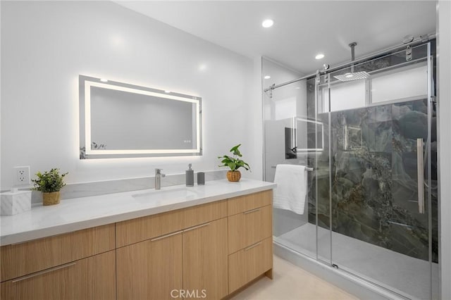 bathroom with an enclosed shower and vanity