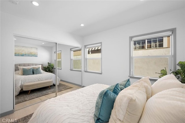 bedroom featuring a closet and light hardwood / wood-style flooring