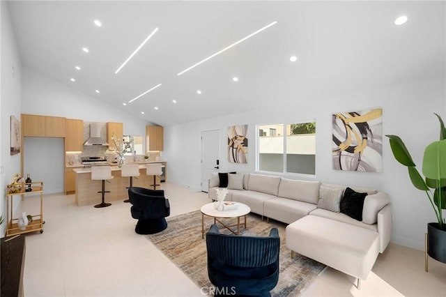 living room featuring high vaulted ceiling