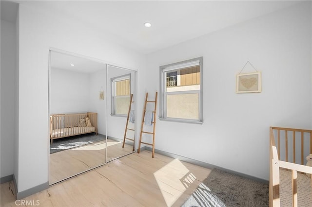 unfurnished bedroom featuring a closet and light hardwood / wood-style flooring