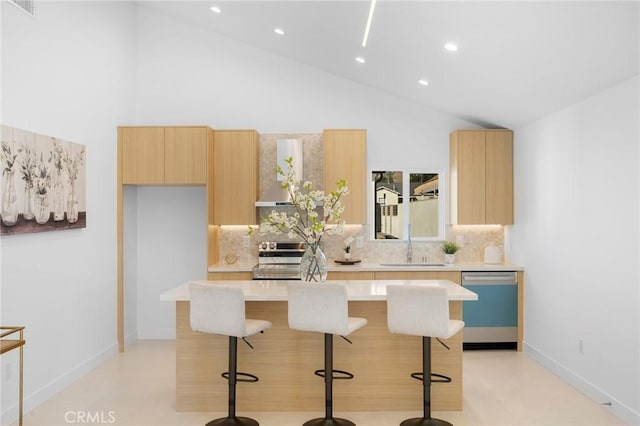 kitchen with high vaulted ceiling, backsplash, wall chimney range hood, and appliances with stainless steel finishes