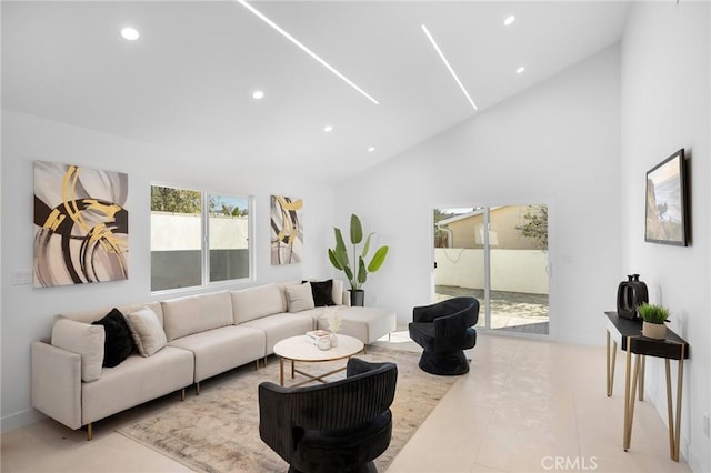 living room with high vaulted ceiling and light tile patterned floors