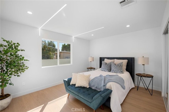 bedroom with hardwood / wood-style flooring