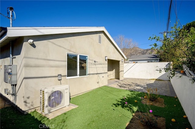 rear view of house with a patio area, a lawn, and ac unit