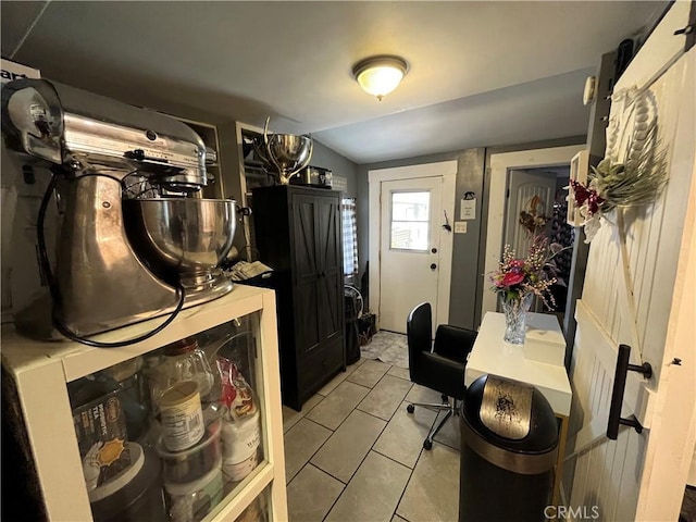 kitchen featuring vaulted ceiling and light tile patterned floors