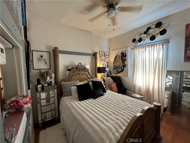 bedroom with hardwood / wood-style floors and ceiling fan