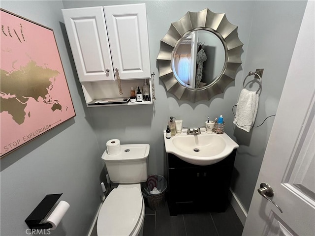 bathroom with tile patterned floors, vanity, and toilet