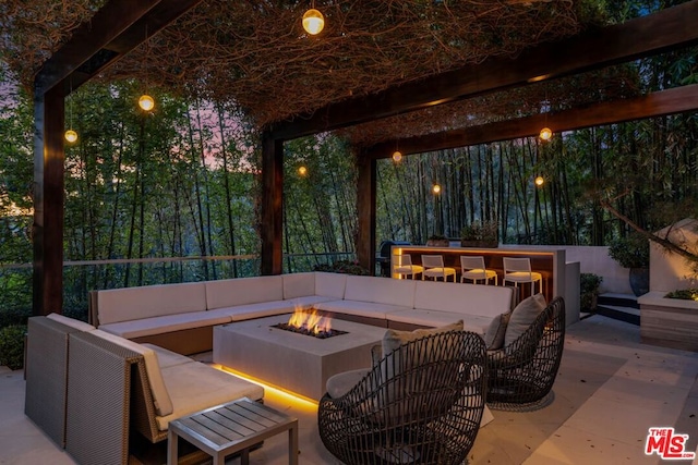 view of patio featuring an outdoor living space with a fire pit