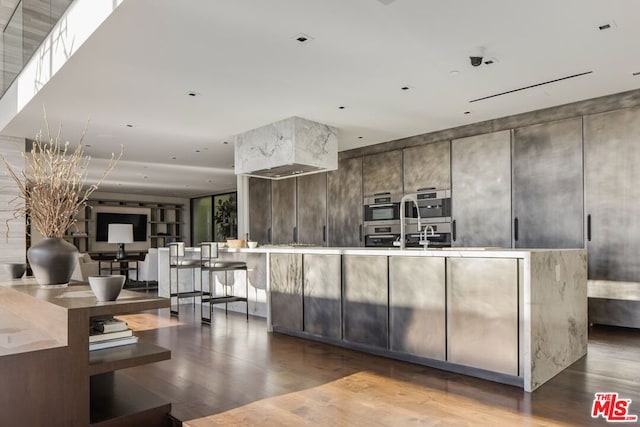 kitchen featuring double oven and dark brown cabinets