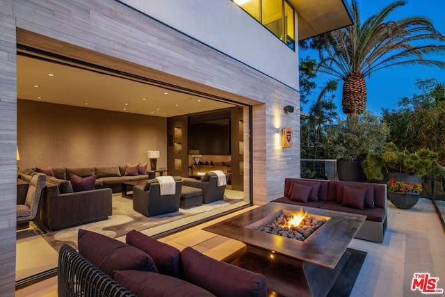 view of patio / terrace featuring an outdoor living space with a fire pit