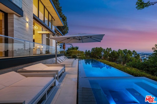 view of pool at dusk