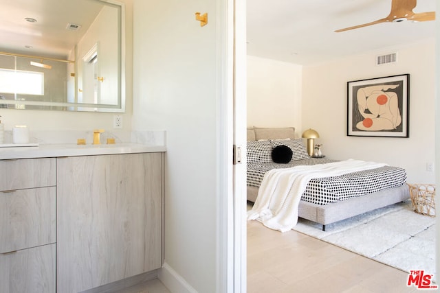 bedroom with ceiling fan, light hardwood / wood-style floors, and ornamental molding