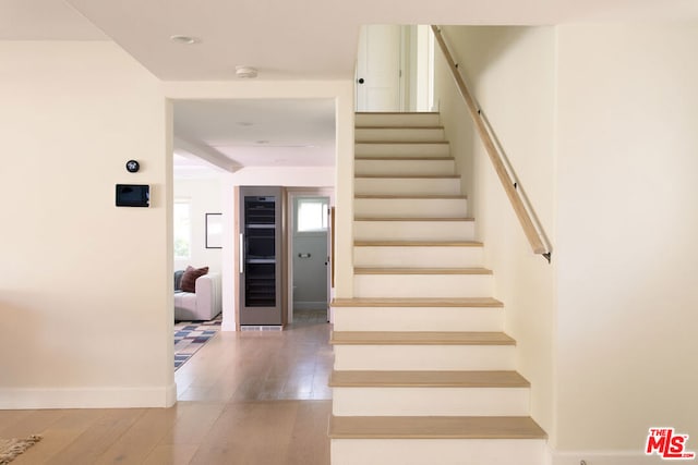 stairs with hardwood / wood-style floors