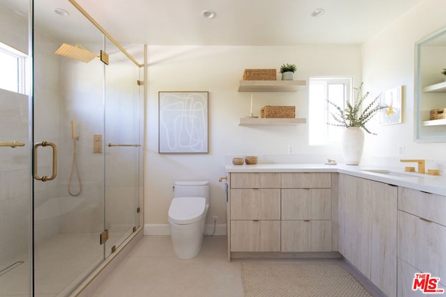 bathroom featuring toilet, vanity, tile patterned flooring, and an enclosed shower