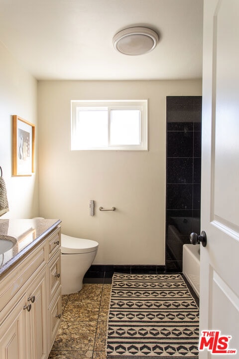 bathroom with tile patterned floors, toilet, and vanity