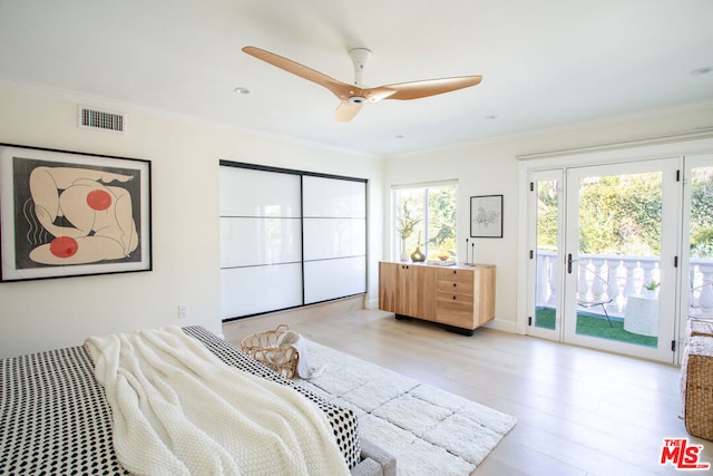 bedroom featuring ceiling fan, light hardwood / wood-style floors, crown molding, and access to outside