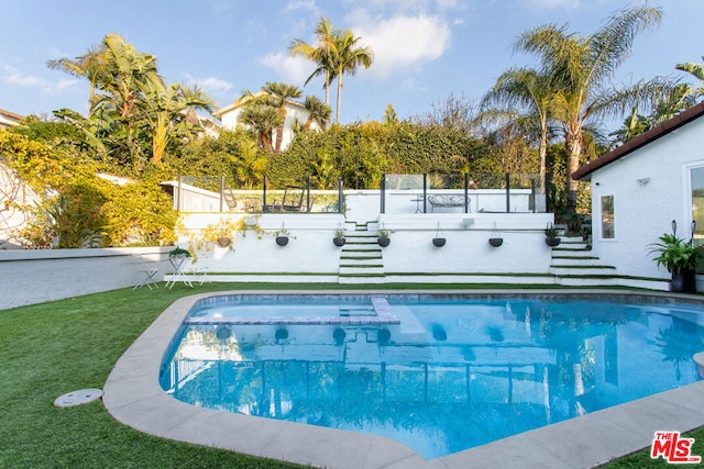 view of pool with a lawn