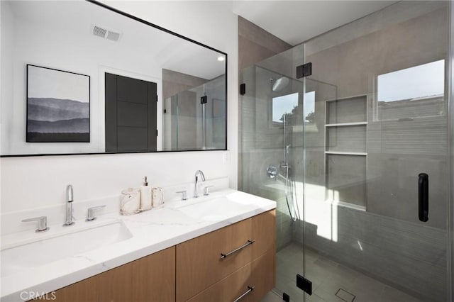 bathroom with an enclosed shower and vanity