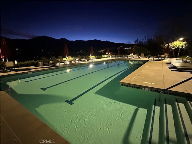 pool at twilight with a mountain view