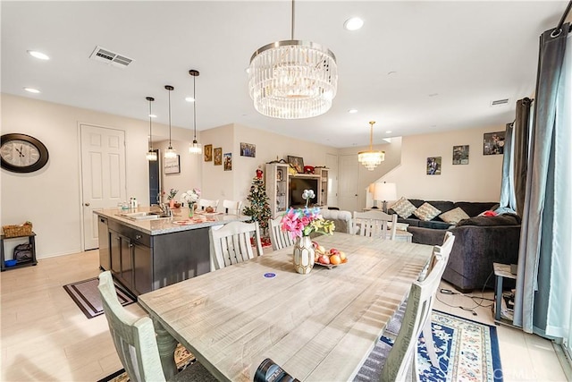 dining area featuring sink and an inviting chandelier