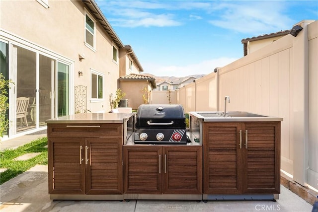 view of patio with area for grilling and exterior bar