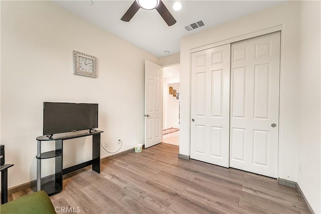 bedroom featuring a closet, ceiling fan, and light hardwood / wood-style flooring