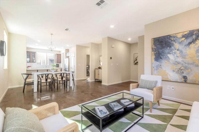 living room featuring hardwood / wood-style flooring and a chandelier