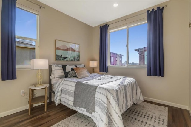 bedroom with dark hardwood / wood-style floors