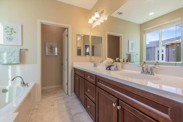 bathroom with vanity and a tub