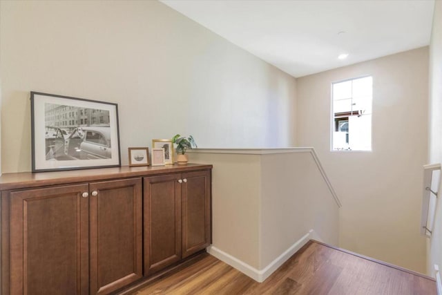 corridor with light hardwood / wood-style flooring