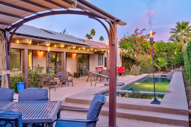 view of patio terrace at dusk