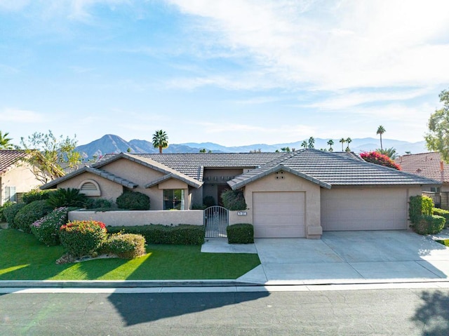 ranch-style home with a garage and a mountain view