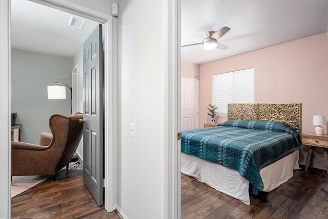 bedroom with ceiling fan and dark hardwood / wood-style floors