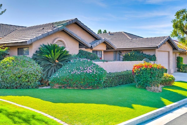 view of front facade with a front yard and a garage