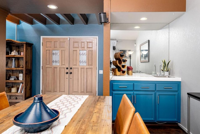 interior space featuring dark wood-type flooring, sink, and beamed ceiling