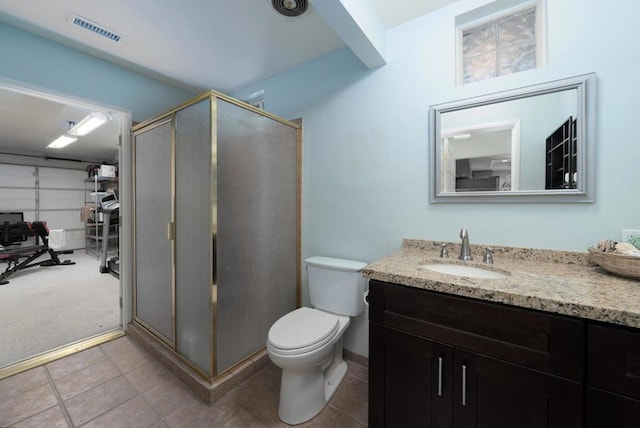 bathroom with toilet, tile patterned flooring, walk in shower, and vanity