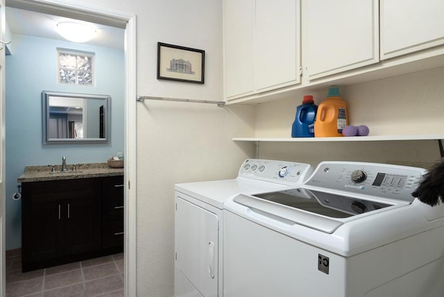 laundry room with sink, tile patterned floors, washer and dryer, and cabinets