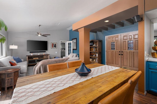 dining space with ceiling fan, vaulted ceiling, and dark hardwood / wood-style floors