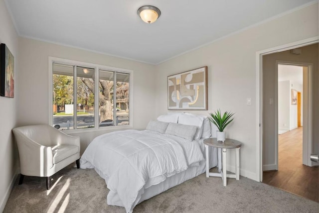 carpeted bedroom featuring ornamental molding