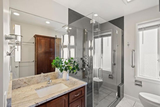 bathroom with a shower with door, toilet, and vanity