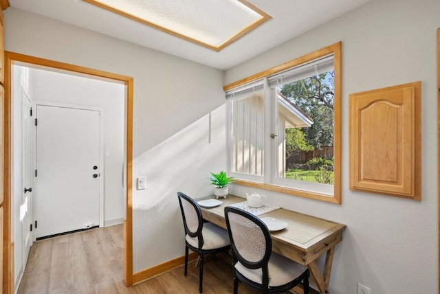 office with light hardwood / wood-style flooring