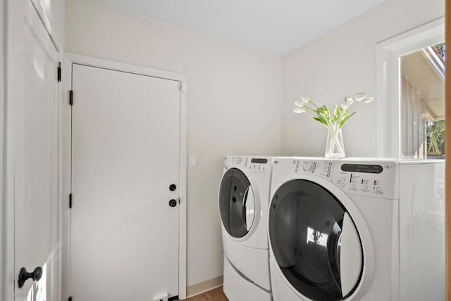 laundry area featuring light hardwood / wood-style flooring and washer and dryer