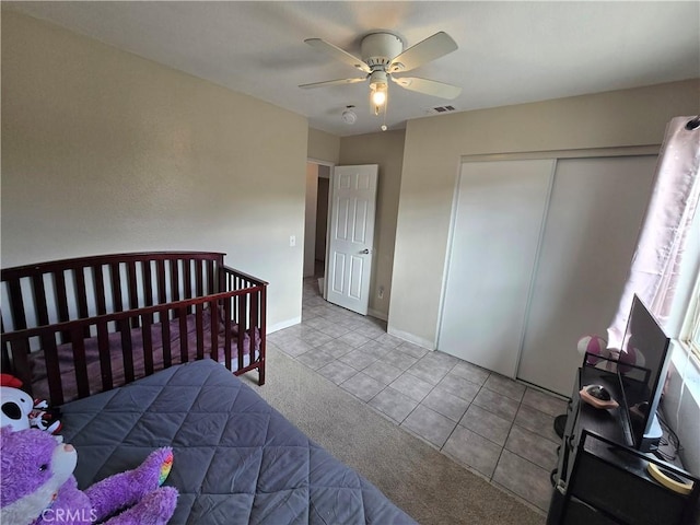 tiled bedroom featuring a closet and ceiling fan