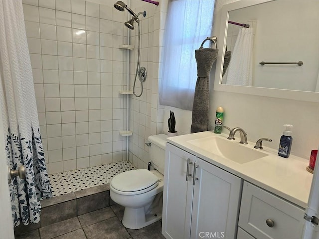 bathroom with vanity, curtained shower, tile patterned floors, and toilet