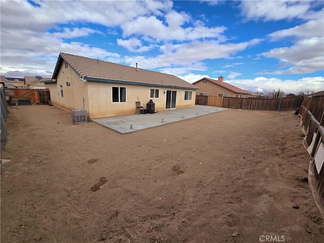 rear view of property featuring a patio area and central air condition unit